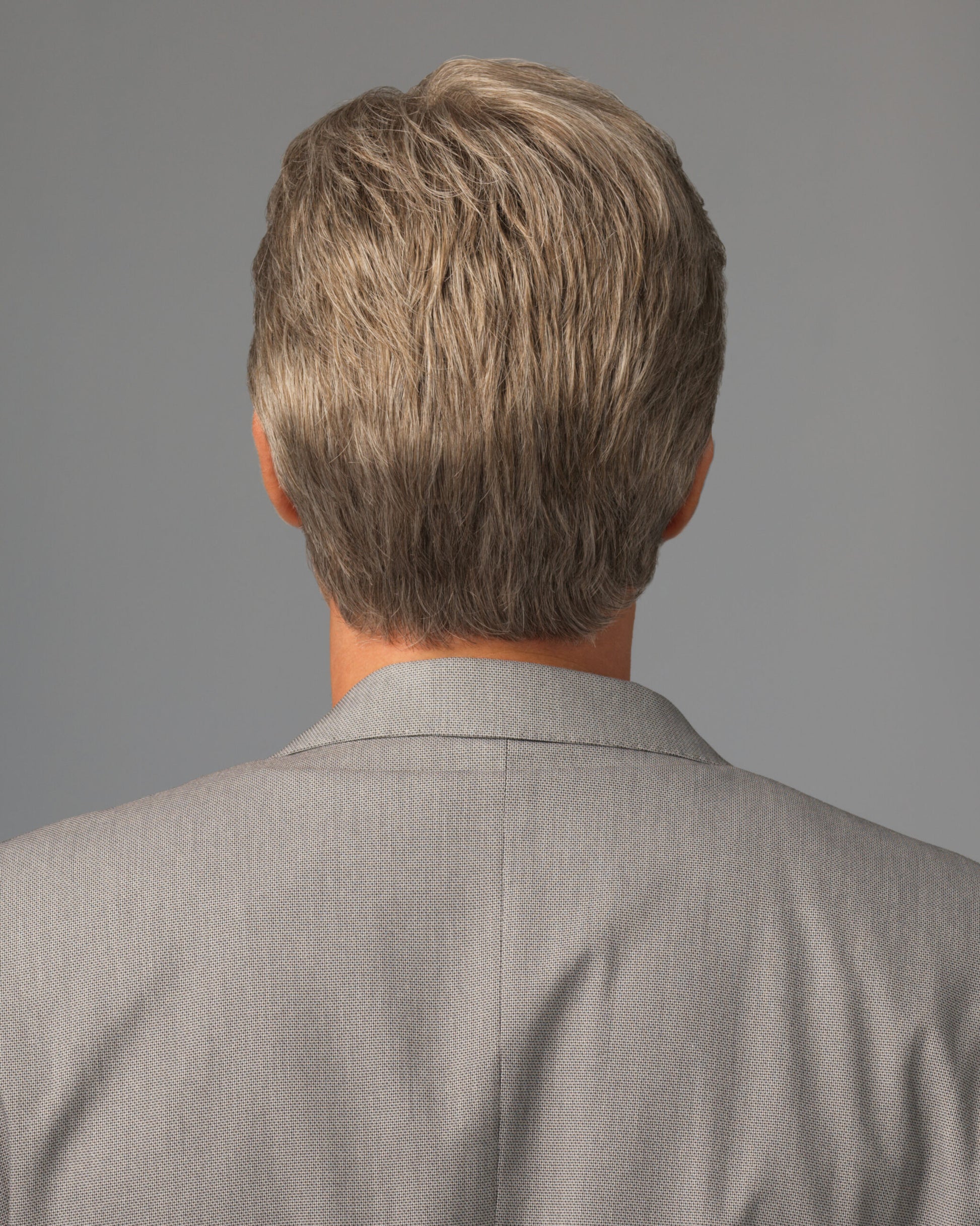 HairUWear back view of a short gray men's wig on model in suit showcasing realistic men's wigs for thinning hair