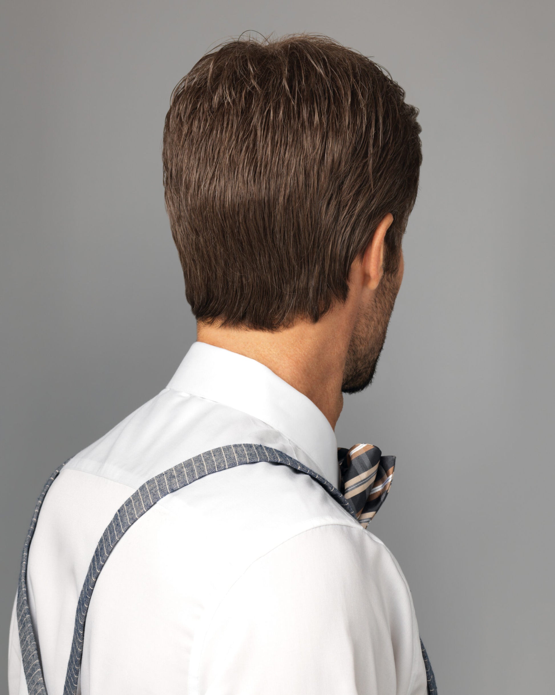 HIM Style men's wig by HairUWear short layered brown back view on model wearing white shirt and bow tie