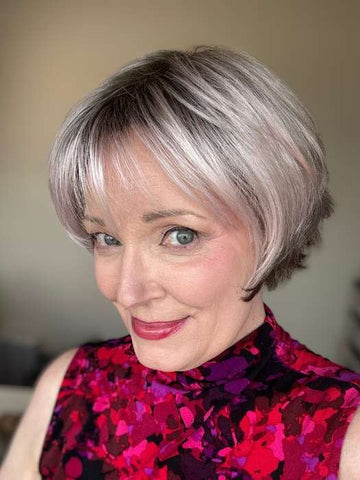 short silver wig for women styled as a layered bob with soft bangs on smiling model