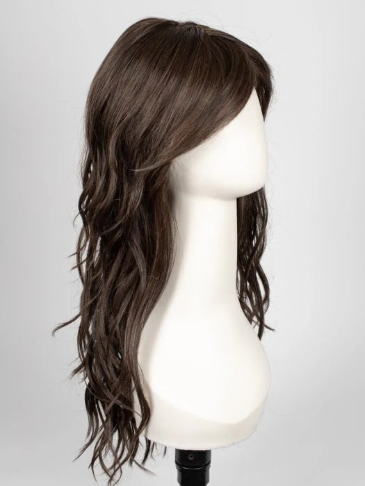 Mannequin displaying long wavy brown wig for women with side swept bangs and layered midback length