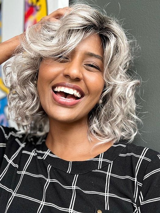 Ellen Wille Girl Mono wig featuring soft, curly layers in a trendy silver color on a smiling model