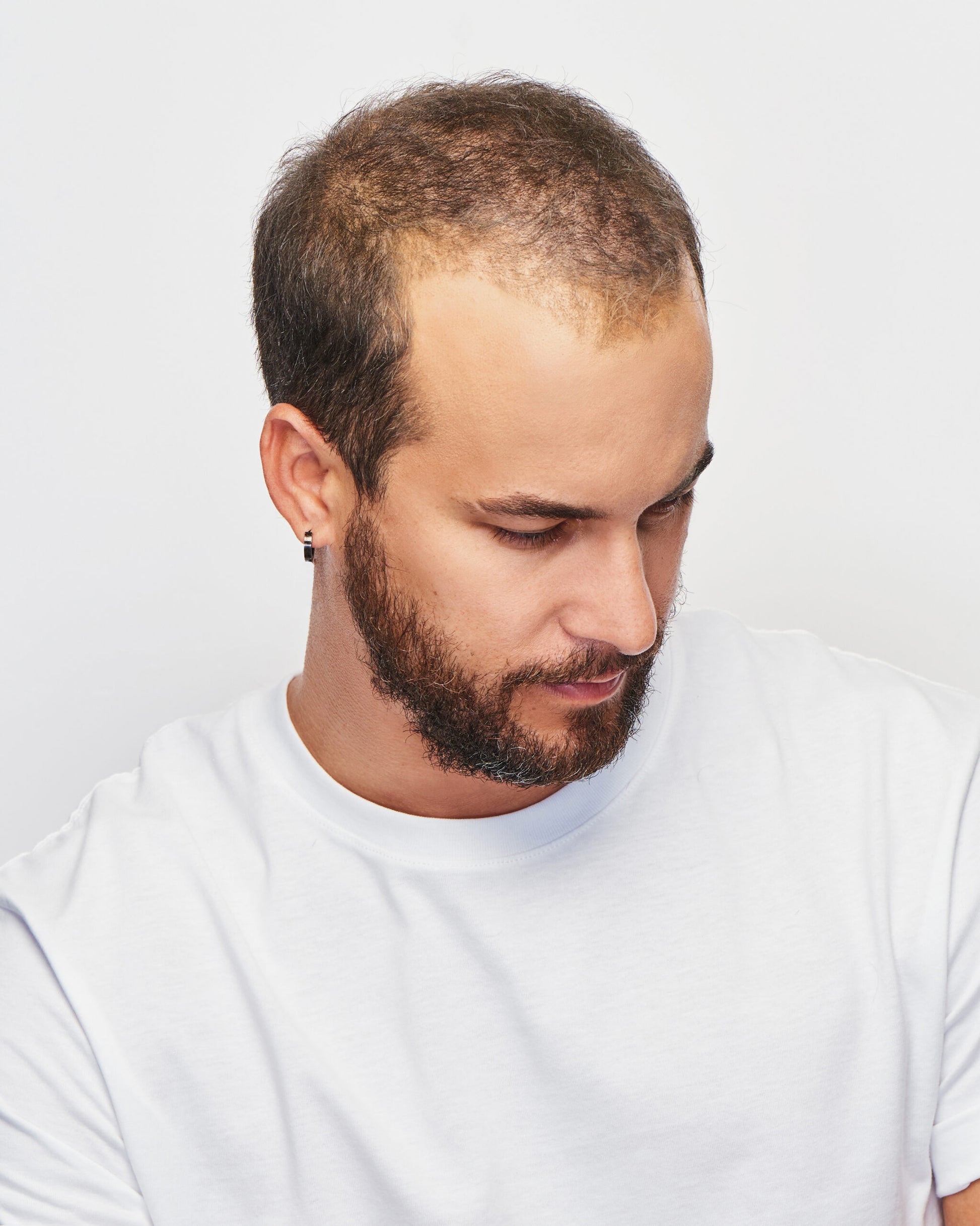 Gallant HIM wig for men realistic short brown hairpiece on bearded man wearing white t shirt looking down