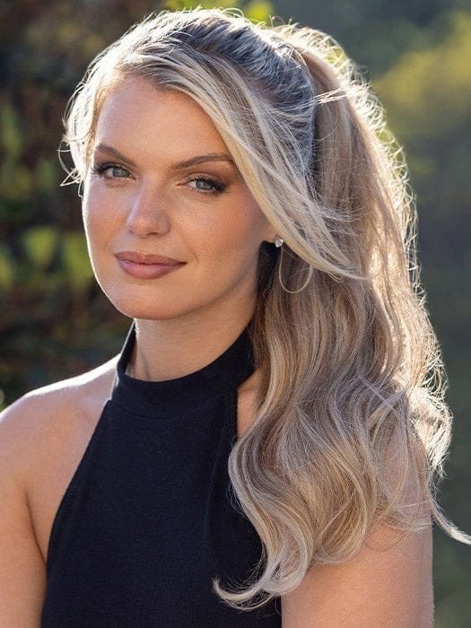 Wigalert model wearing long wavy blonde synthetic ponytail clip for easy clip in volume and style