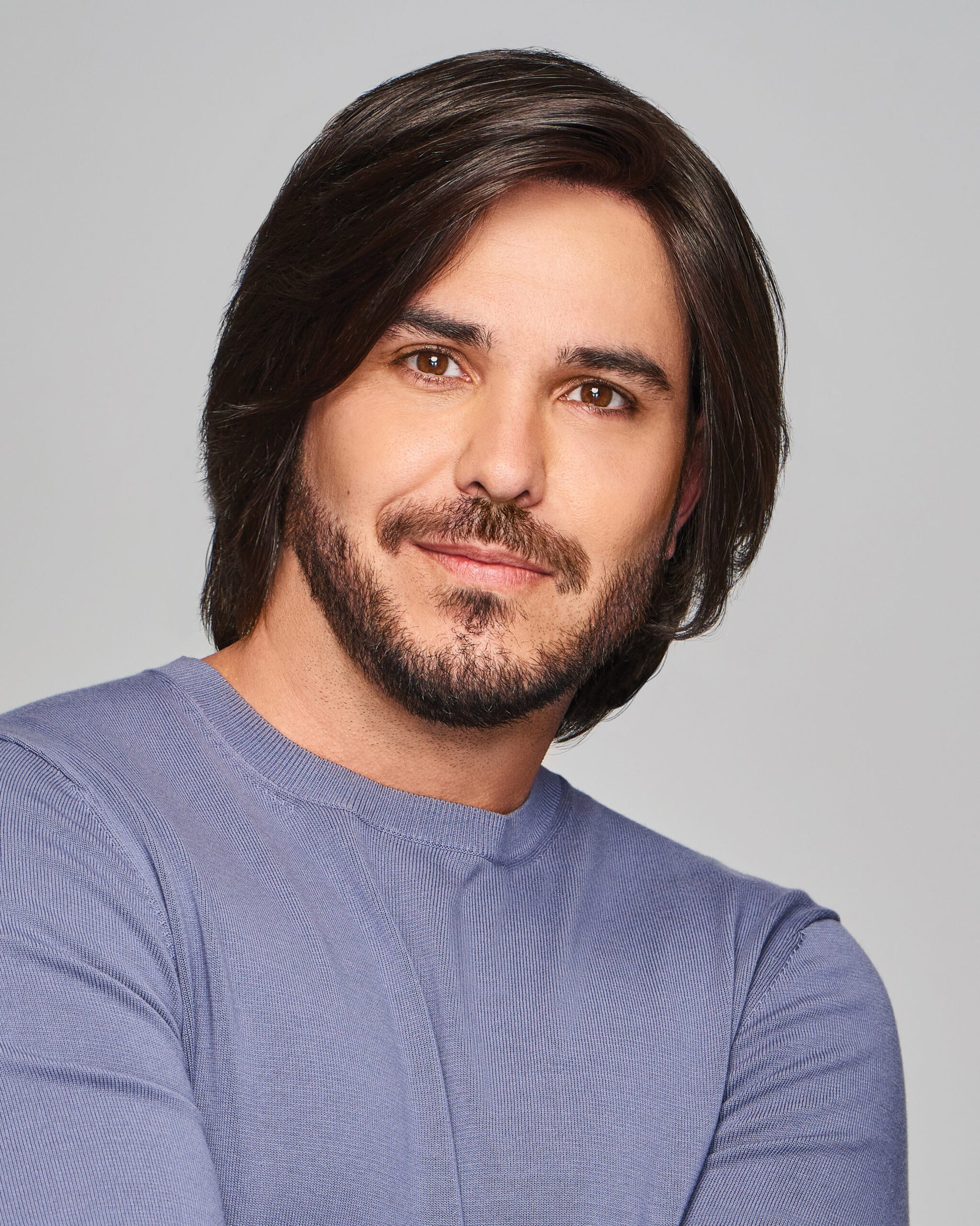 Sharp HIM wig for men on male model with medium brown layered side part hair, natural hairline and light beard