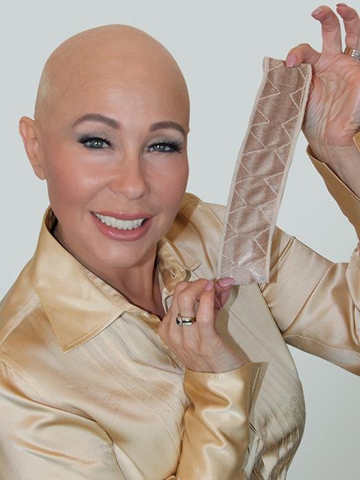 Woman holding a reversible wig grip for sensitive scalp, designed for comfort and stability under wigs