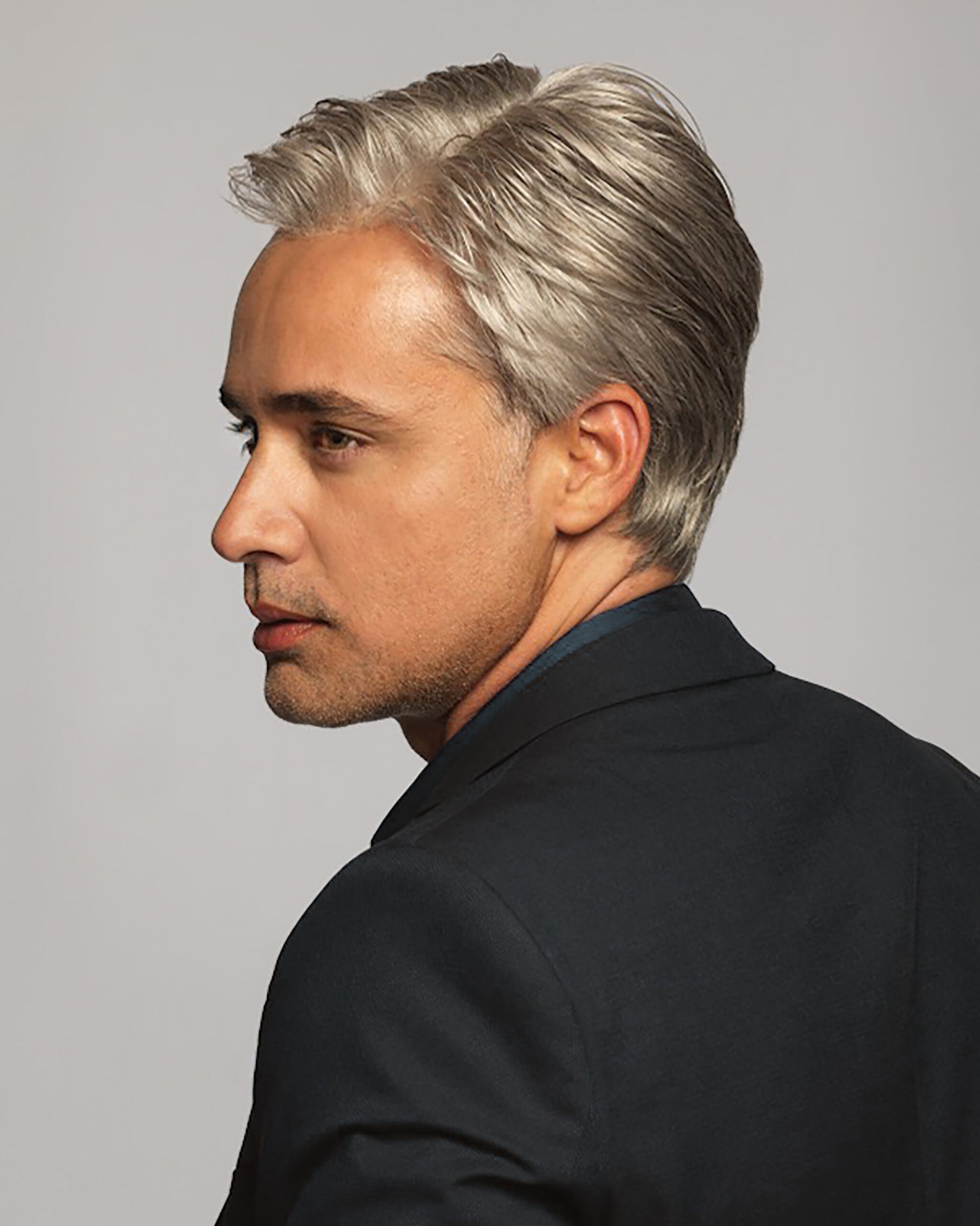 Silver gray men's classic wig on mature man side profile styled short swept back for professional look