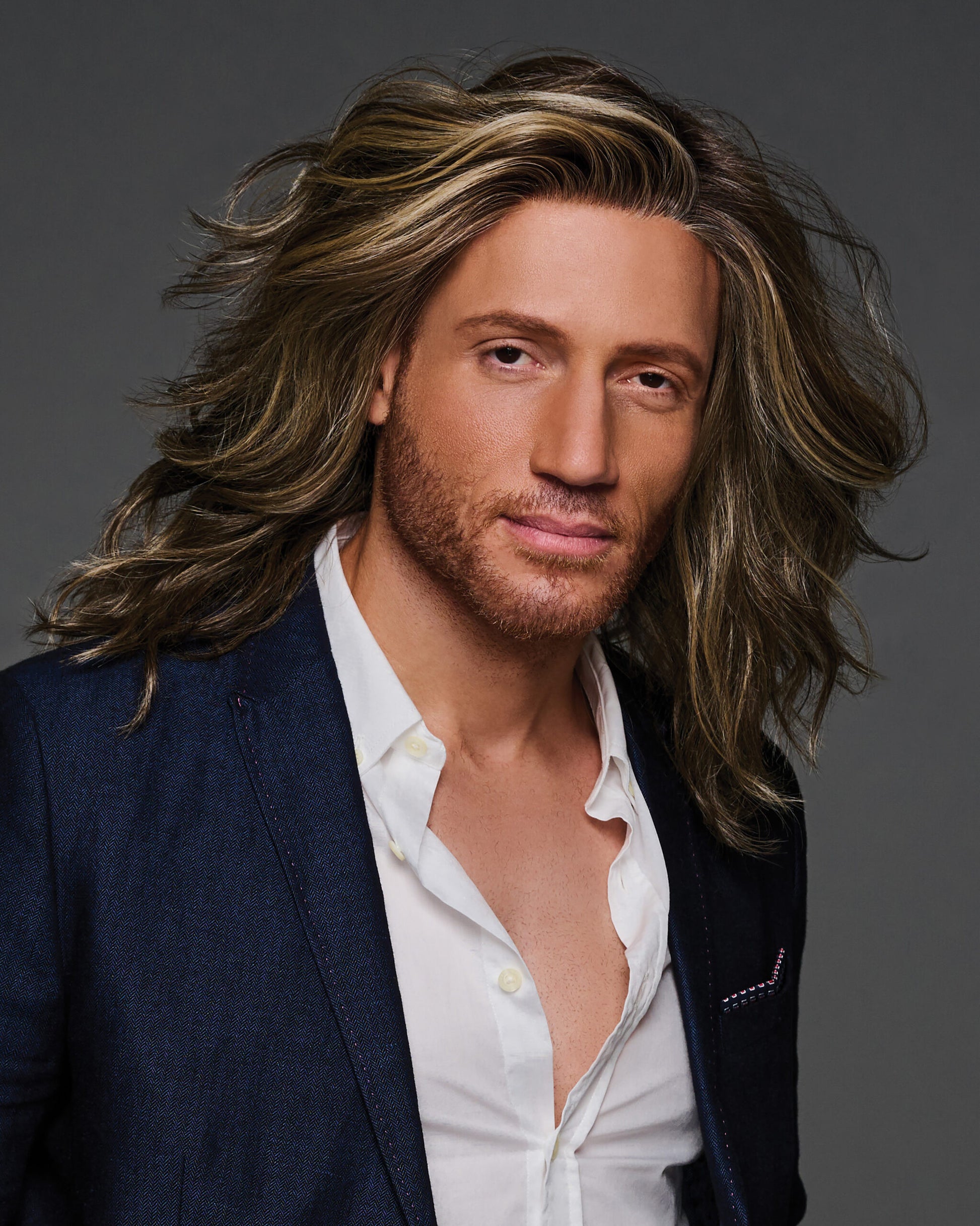 Admirable HIM wig for men. Long layered chestnut brown wig with blonde highlights, natural part, tousled look on male model